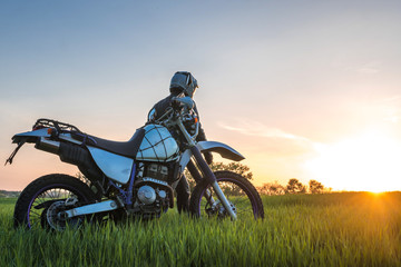 Fototapeta premium Motorcyclist on green grass off road, enduro, extreme sport, active lifestyle, adventure touring concept, enduro outdoor