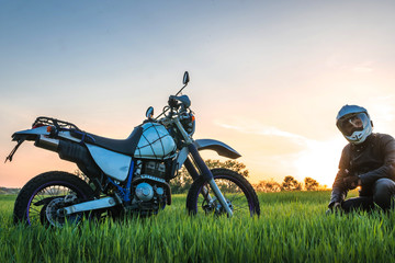 Obraz na płótnie Canvas Motorcyclist on green grass off road, enduro, extreme sport, active lifestyle, adventure touring concept, enduro outdoor