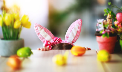 Happy easter! funny child girl with rabbit ears and . eggs  .