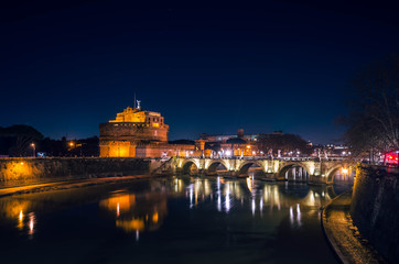 Fototapeta na wymiar Night view of the Castle of the Holy Angel (Castel Sant' Angelo ), one of the top sights in Rome situated in short distance from Vatican.