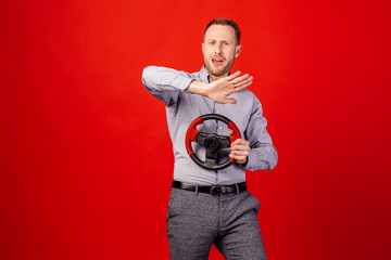 Bearded man with a steering wheel, car drive concept.