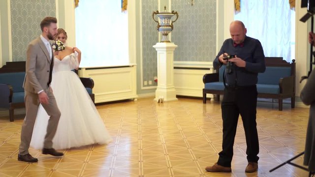 backstage wedding photography - professional photographers take pictures of newlyweds in a chic room
