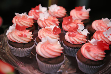 chocolate cupcakes with meringue cream and fruit. Candy bar at a party. Selective focus.