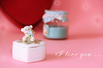 silver ring with precious red stones on the background of a decorative white ceramic casket with a gift