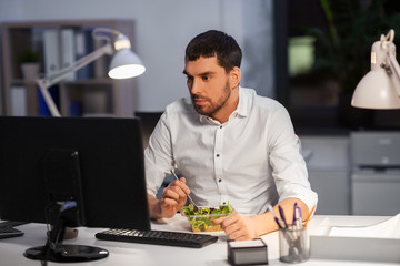business, overwork, deadline and people concept - businessman with computer eating at night office