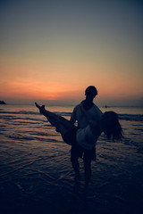 Silhouette of a girl in sunset / sunrise time over the ocean.
