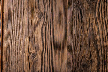 Old dark brown wooden wall, detailed background photo texture. Wood plank fence close up.