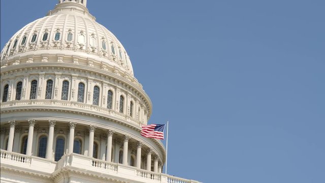 Close-up of the United States Capitol dome and flag, Washington DC, District of Columbia