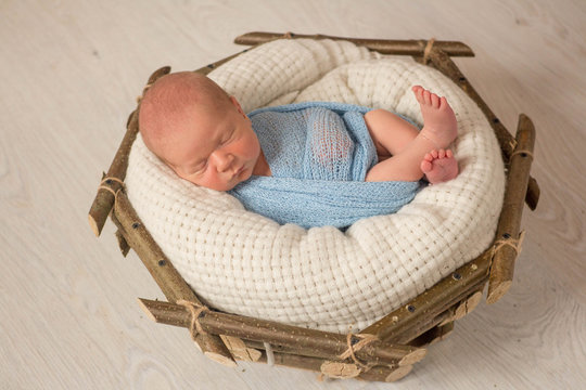 newborn baby. the first photo shoot of a newborn. the baby in the basket. wooden basket	