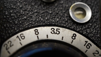 Macro close up of aperture dial on a vintage twin reflex medium format 1940s film camera in the studio, with film frame counter window