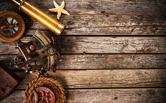 Top view of vintage navigation equipment on wooden table.