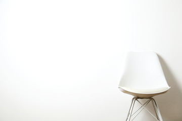 Empy loft style chair over blank wall background wit a lot of copy space for text. Available job position, interview or negotiations concept.