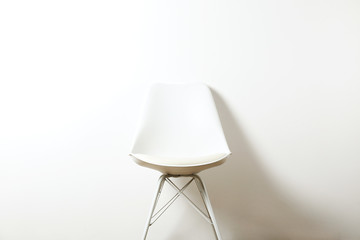Empy loft style chair over blank wall background wit a lot of copy space for text. Available job position, interview or negotiations concept.