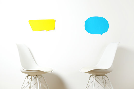 Empy loft style chair over blank wall background wit a lot of copy space for text. Available job position, interview or negotiations concept.