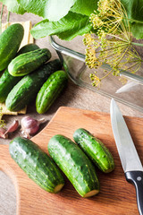 Fresh cucumbers on wooden board prepared for pickling