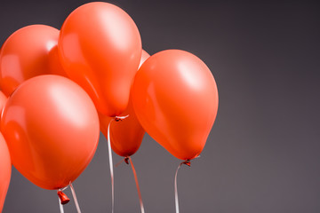 coral air balloons on grey background, color of 2019 concept