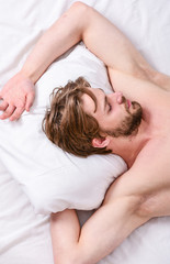 Obraz na płótnie Canvas How much sleep you actually need. Bearded man sleeping face relaxing on pillow. Man handsome guy lay in bed. Get adequate and consistent amount of sleep every night. Expert tips on sleeping better