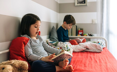 Girl and boy reading a book