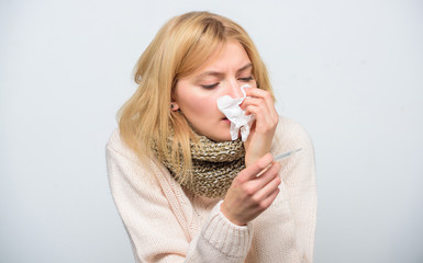 How to bring fever down. Sick girl with fever. Girl sick hold thermometer and tissue. Measure...