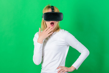 Woman enjoying cyber fun experience in vr. Woman with virtual reality headset. Cheerful smiling...