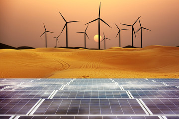 Renewable energy with windmills and solar panels in dessert at sunset