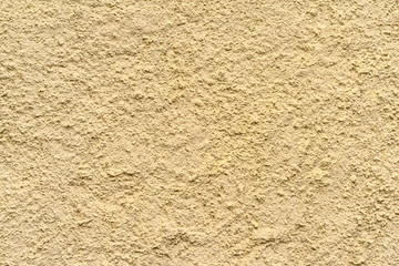 The plastered wall in yellow color. Vintage background