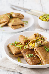 Rye crepes with corn and turkey filling. Healthy eating concept.