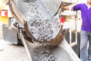 Mixer truck transport cement to the falsework of  small building on the construction