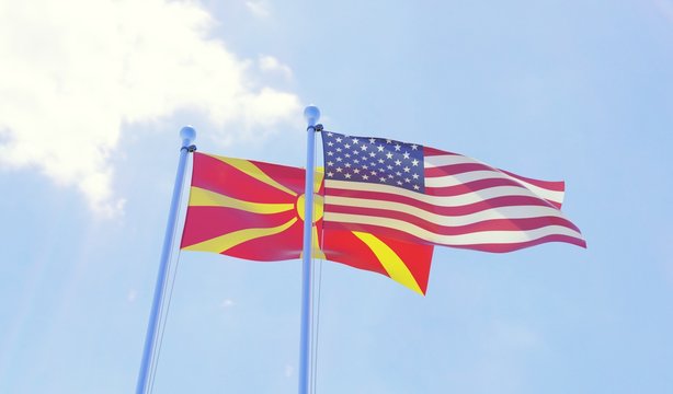 Macedonia and USA, two flags waving against blue sky. 3d image