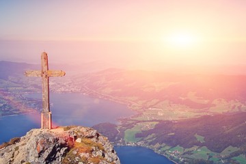 Religious and believe concept: wooden orthodox cross silhouette on the mountain lake landscape at...