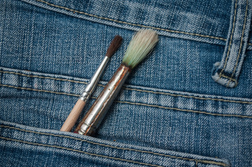closeup of bruches in blue jeans pocket