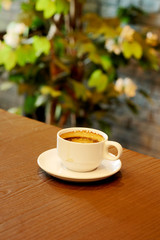 Well mixed hot black coffee in white coffee cup with space for write wording served in a restaurant in a coffee break time, popular drink for meeting place and party time, value added design for bette