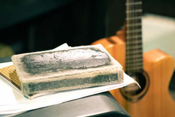 the old diary is next to the guitar, a set of lyrics for performances