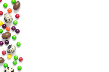  Easter eggs, multicolored sweets , white  background.  Concept of celebrating Easter, Easter decorations. Flat lay, top view. Copy Space.