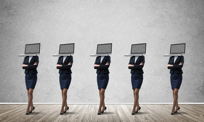 Business women with laptops instead of head.