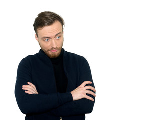 Obraz premium Portrait of a disillusion man standing with hands crossed, isolated on a gray background .