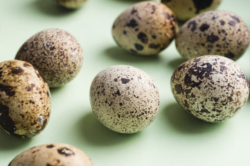 heap of quail eggs on color background. Vegetarian organic  eco food.