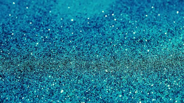 Turquoise Holiday abstract glitter background with blinking lights.