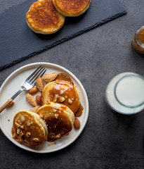 Breakfast with blini with caramel at black background