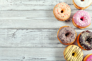 Glazed donuts on wooden background