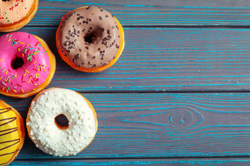 Glazed donuts on wooden background