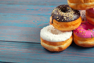 Glazed donuts on wooden background