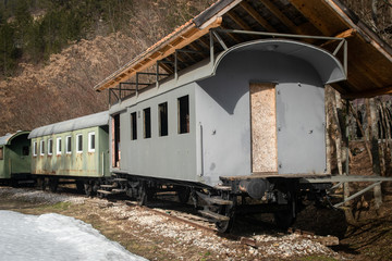 Fototapeta na wymiar Old freight train containers with narrow gauge railway track