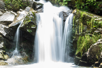 Fototapeta na wymiar Forest waterfall Kamenka
