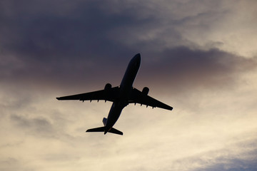 Fototapeta na wymiar Passenger airplane taking off in sunset
