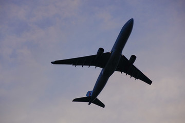Fototapeta na wymiar Passenger airplane taking off in sunset