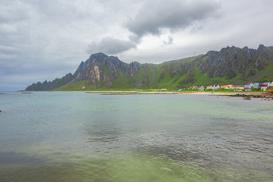 The village of Bleik squized between the mountains and the sea, seen from the harbor