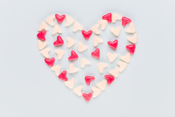 Valentines day background pastel hearts on blue wooden background.