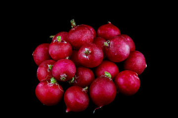 Red Radishes Against a Black Background