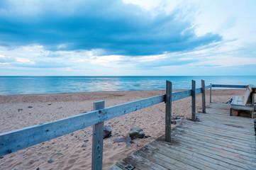 Bench on the Inverness beach at sunset, Nova Scotia, Canada